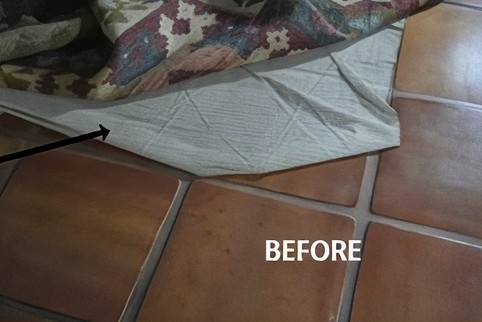 Untreated rug backing with visible wrinkles and folds that may cause the rug to shift.